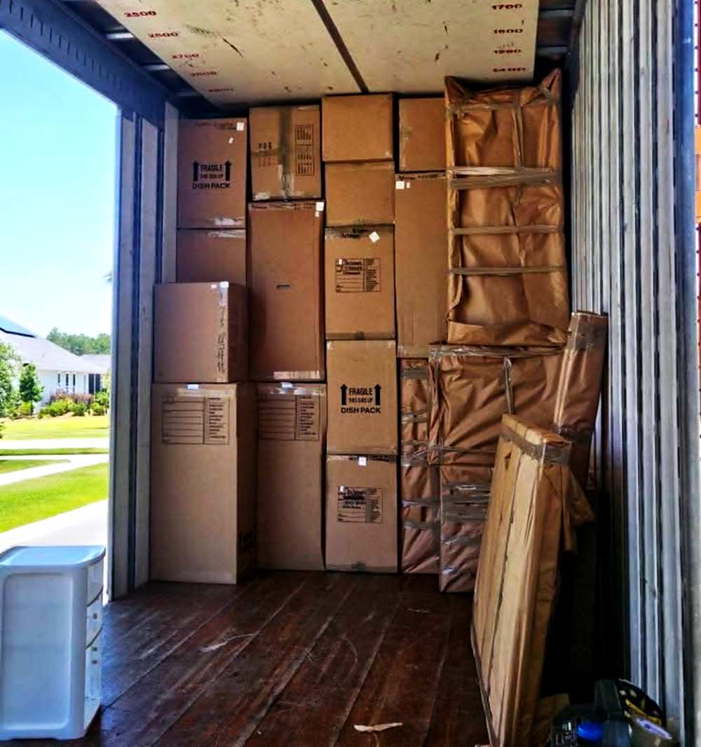 Looking out of a packed truck to the house being moved